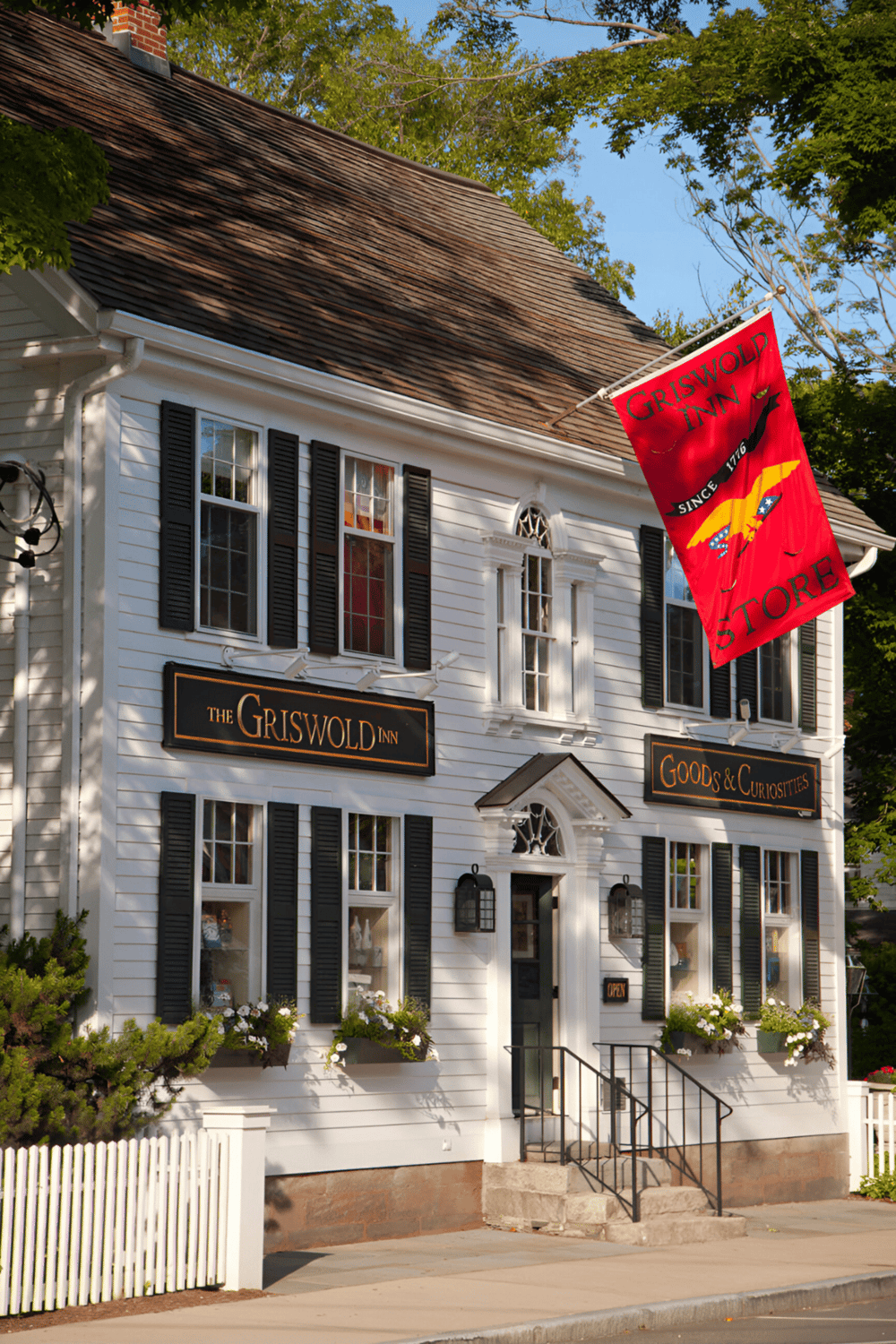 Charming historic inn with storefront, vintage signage, and welcoming curb appeal.