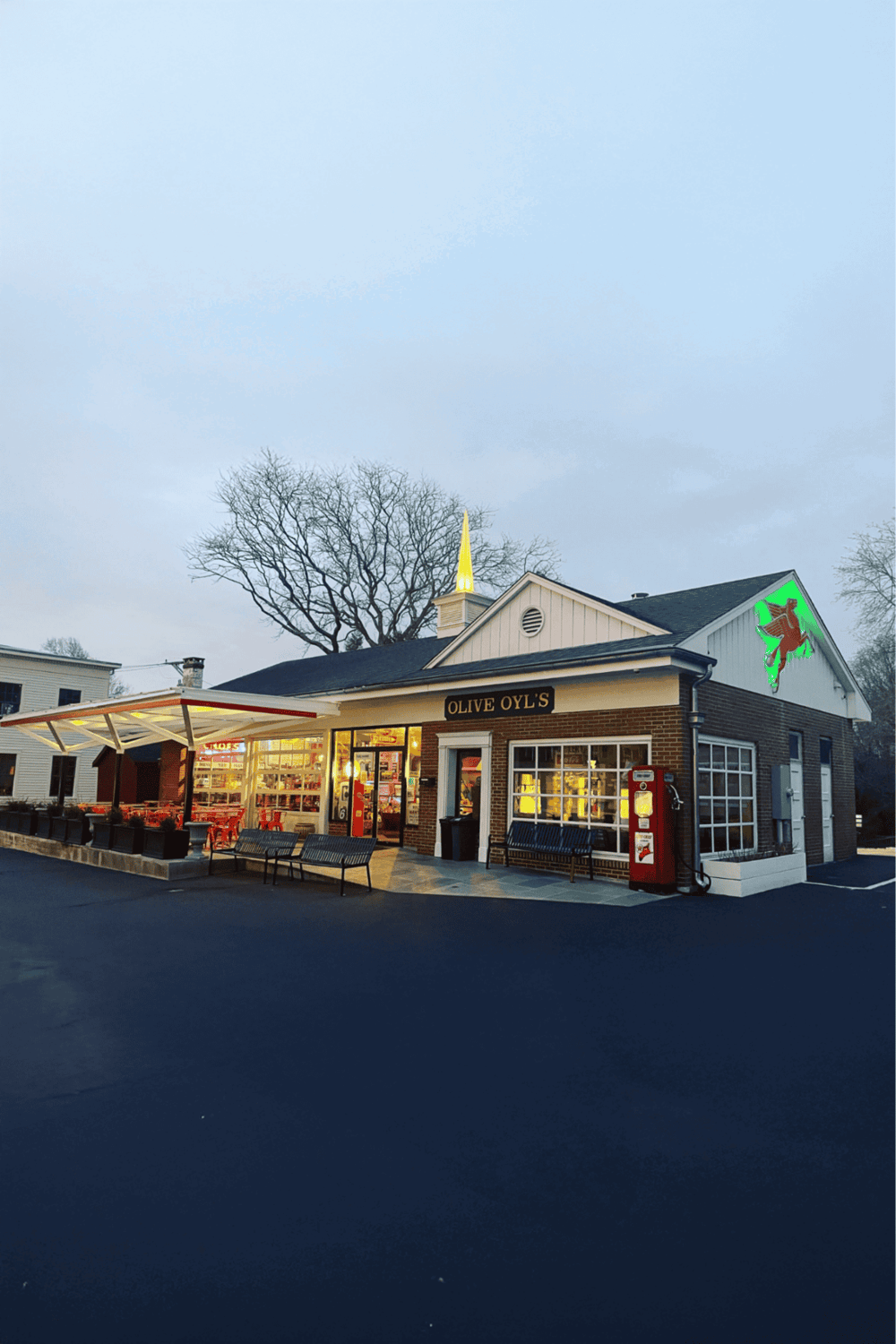 1. Cozy restaurant exterior in a suburban area with outdoor seating, illuminated in the evening.