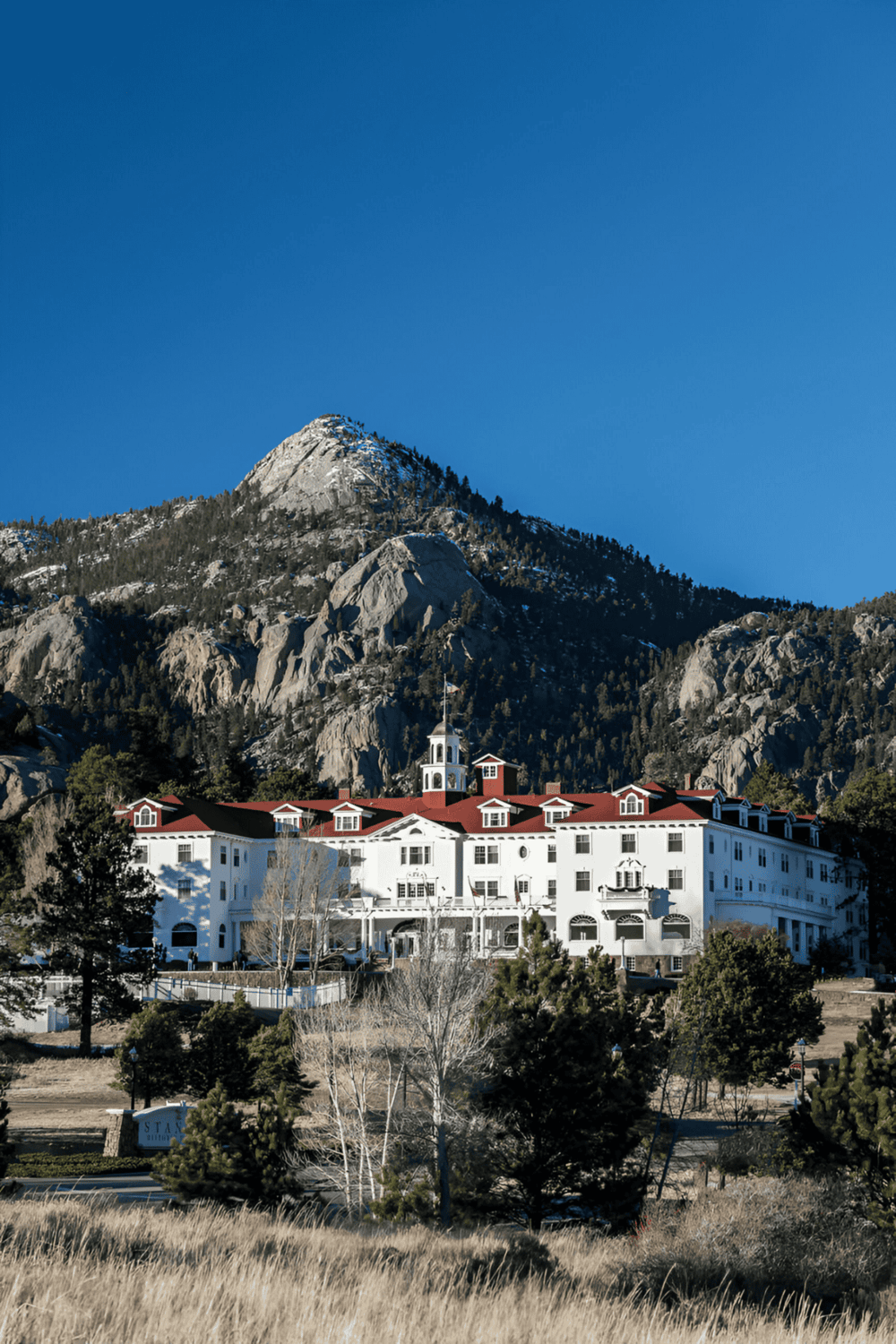 Mountain resort with red-roofed buildings and scenic mountain backdrop, perfect for outdoor adventures and relaxation.