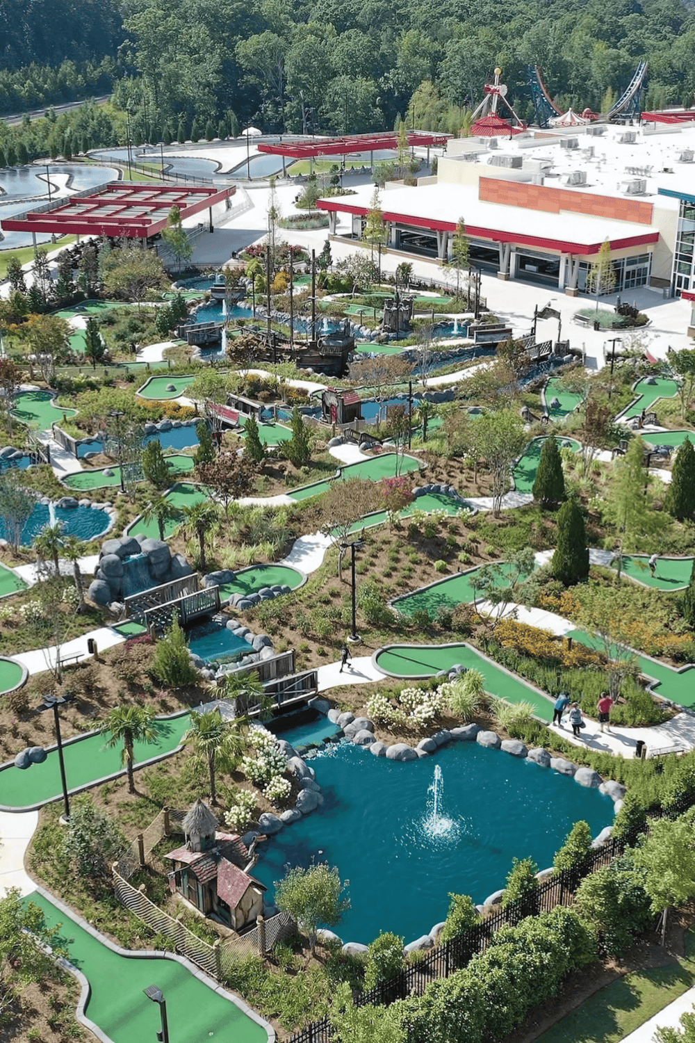 Miniature golf course with waterfalls and lush landscaping at Quest for Directions amusement park.