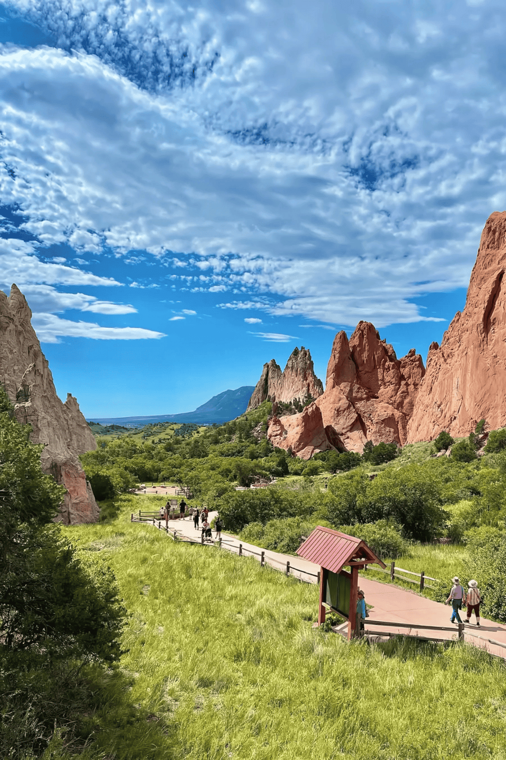 Breathtaking mountain valley with red rock formations and lush green scenery, perfect for nature enthusiasts.