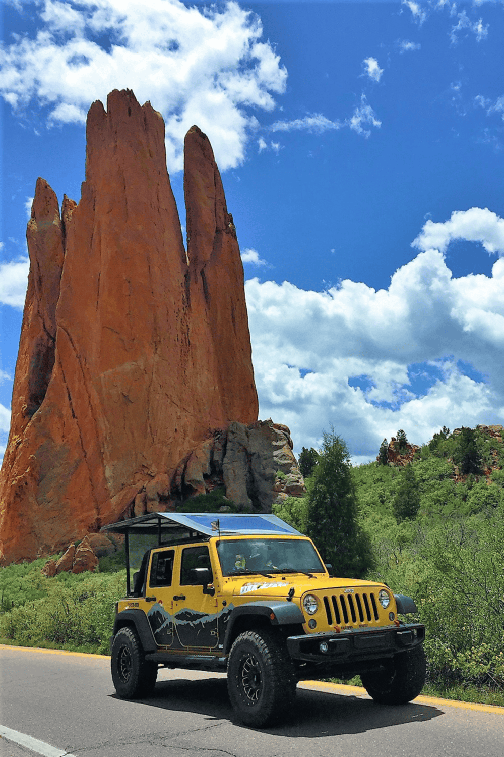 Majestic red rock formations in Colorado with a yellow Jeep enjoying scenic adventure.