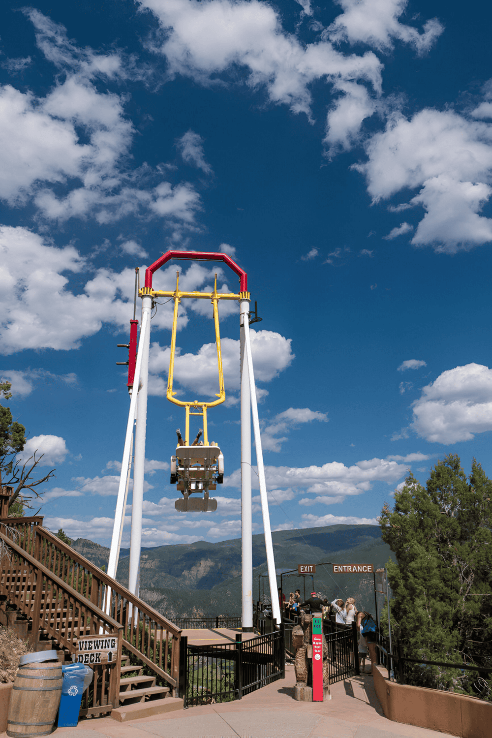 Historic mountain swing ride at Quest for Directions theme park under blue sky.