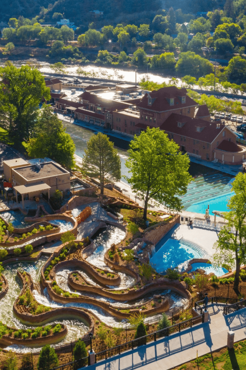 Water park with lazy river and slides in a scenic outdoor setting, perfect for family fun and relaxation.