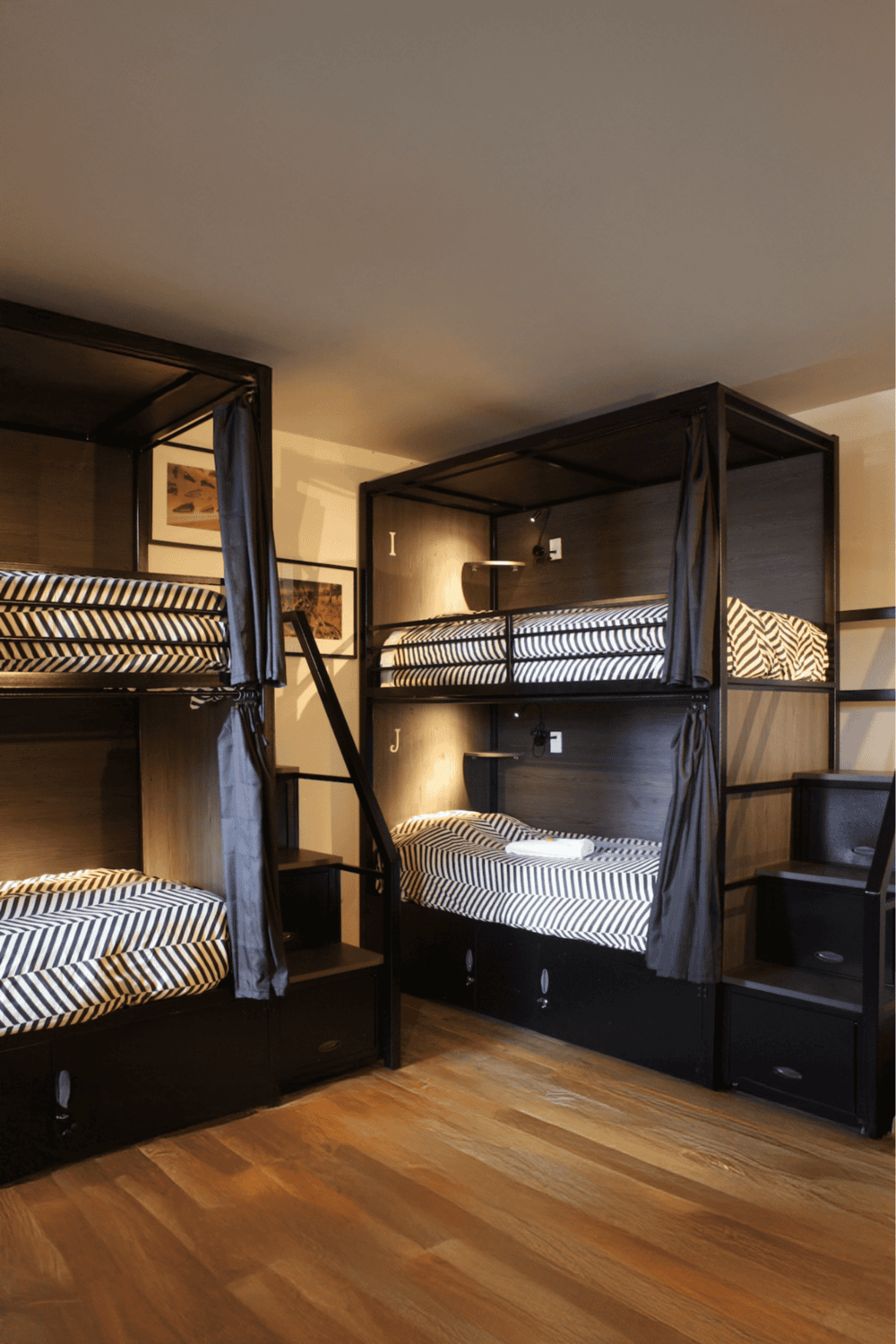 Cozy bunk bed dorm room with black metal frame and striped bedding at QuestForDirections.
