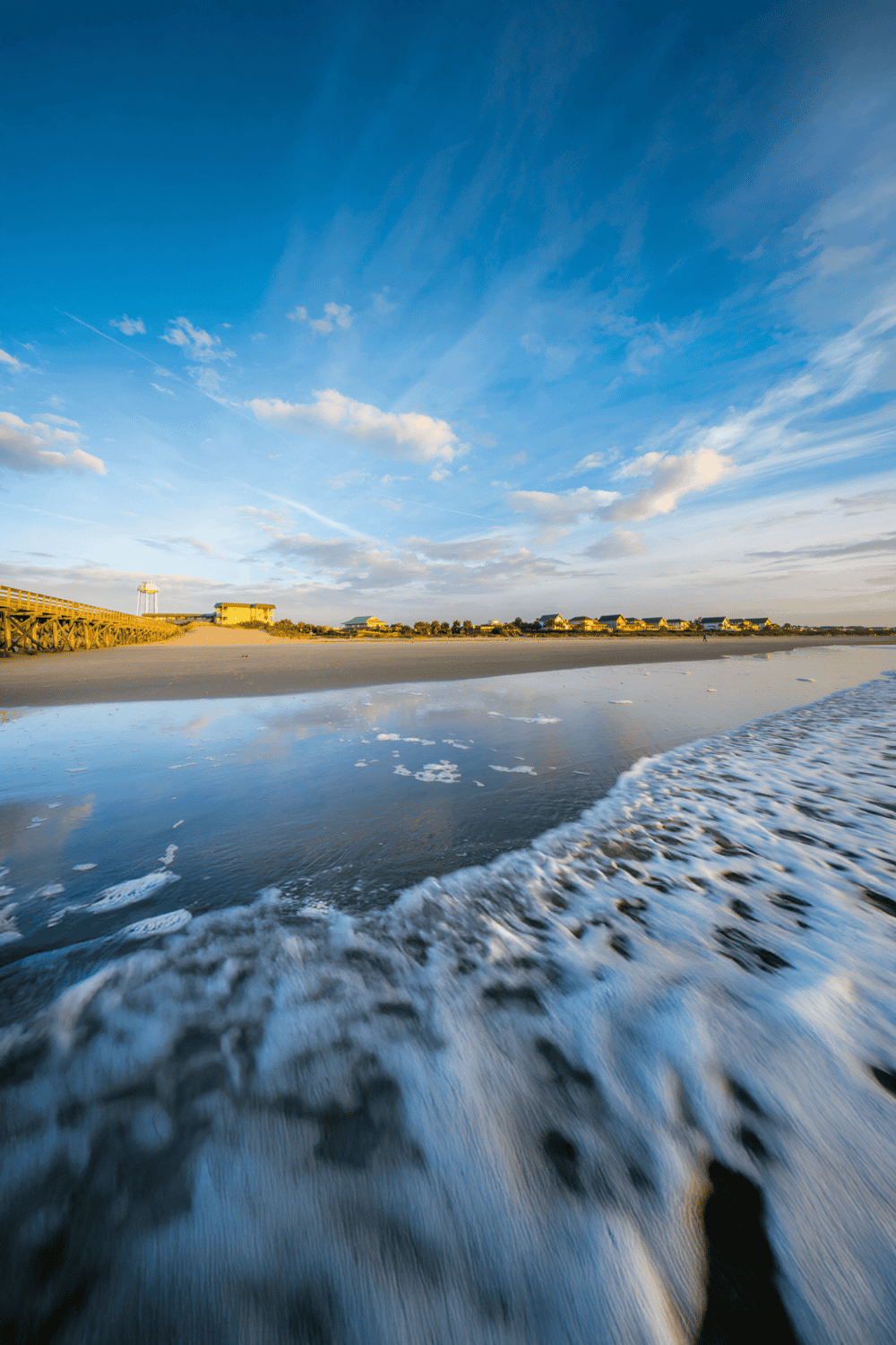 Beach with waves and skyline during sunset, coastal landscape, scenic seashore, beautifully lit seaside scene, quest for directions outdoor scenery.