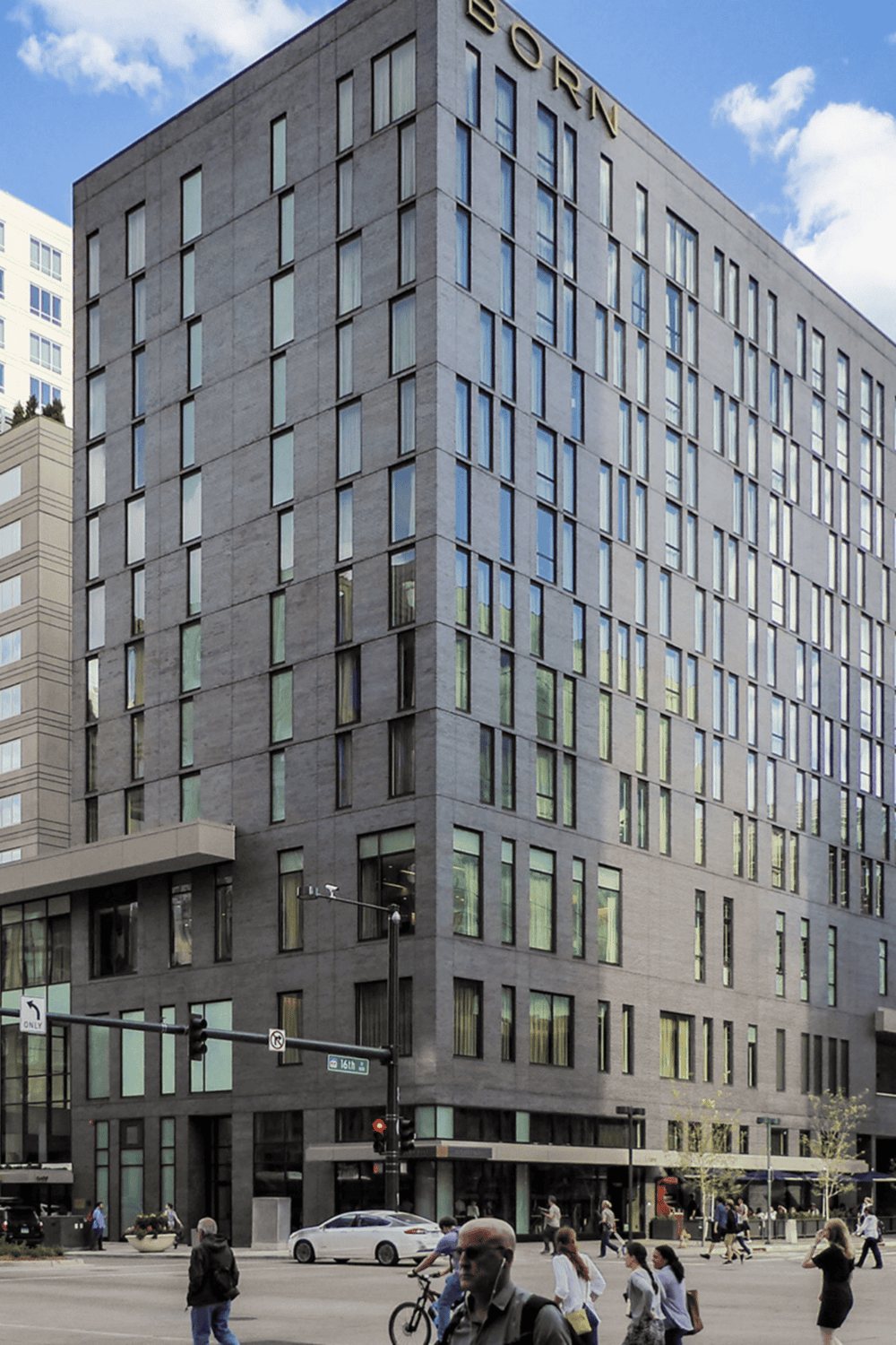 Modern office building with sleek glass windows in an urban setting.