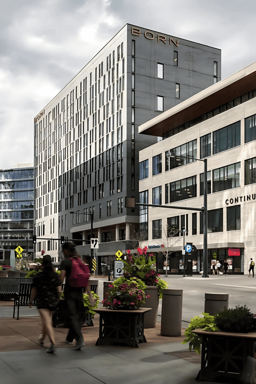 Modern cityscape with Quest for Directions building, showcasing urban architecture and street scene.