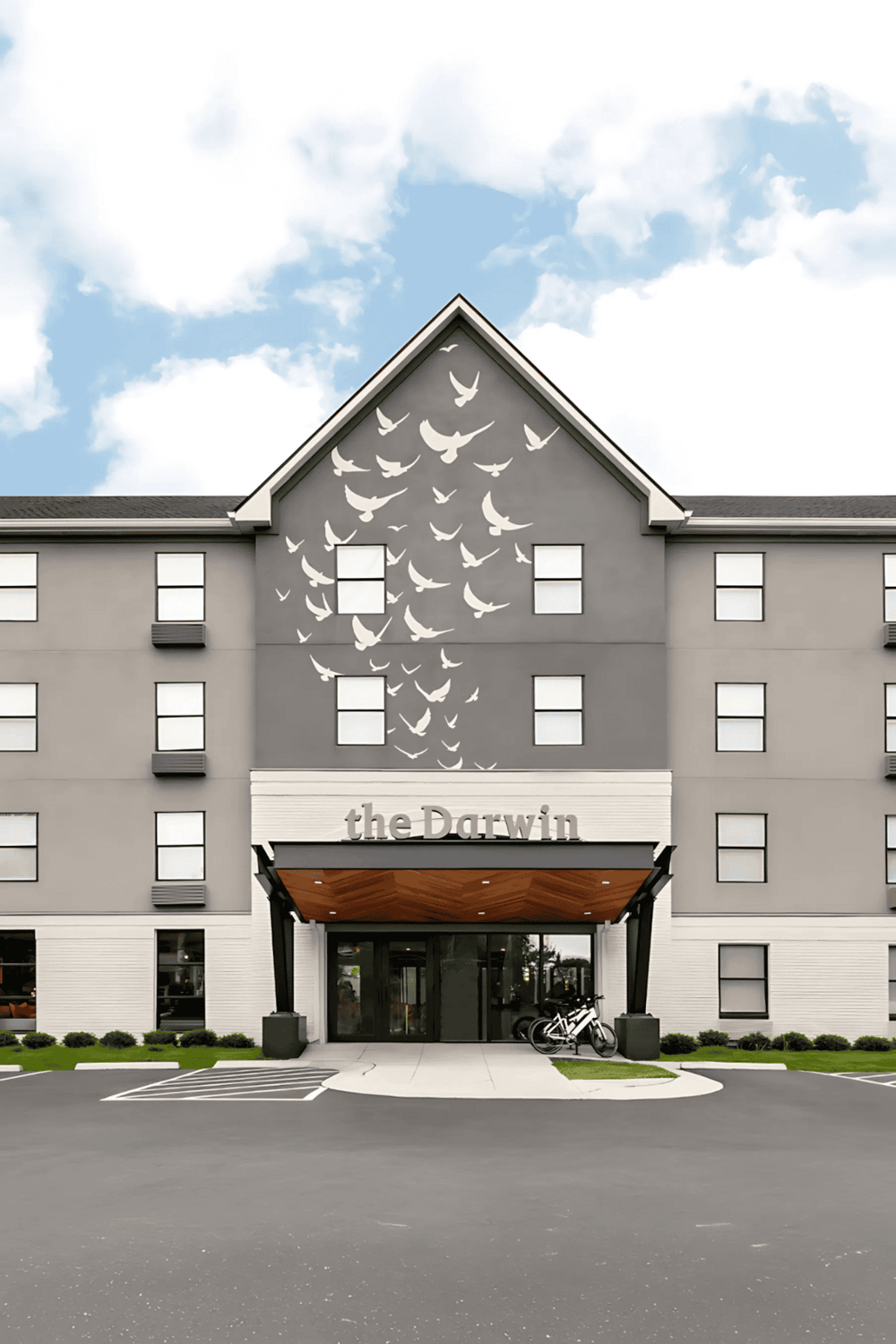 Modern residential building named the Darwin with bird mural artwork exterior design.