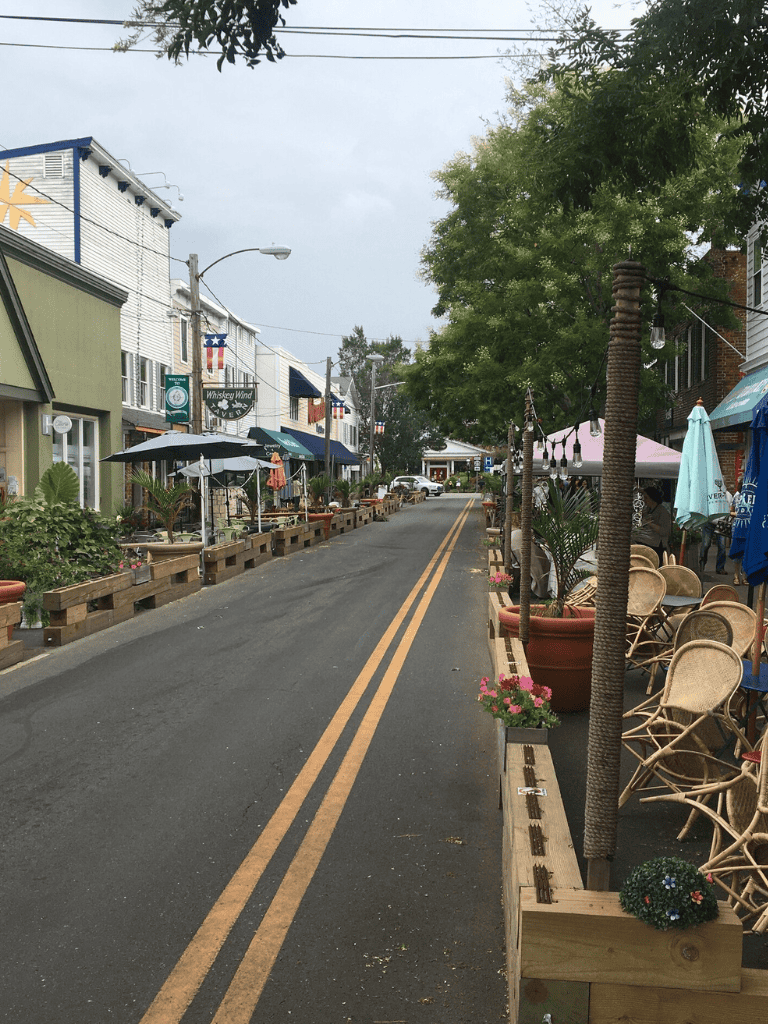 Relaxed street scene with outdoor cafes and boutique shops, perfect for exploring local dining and shopping.
