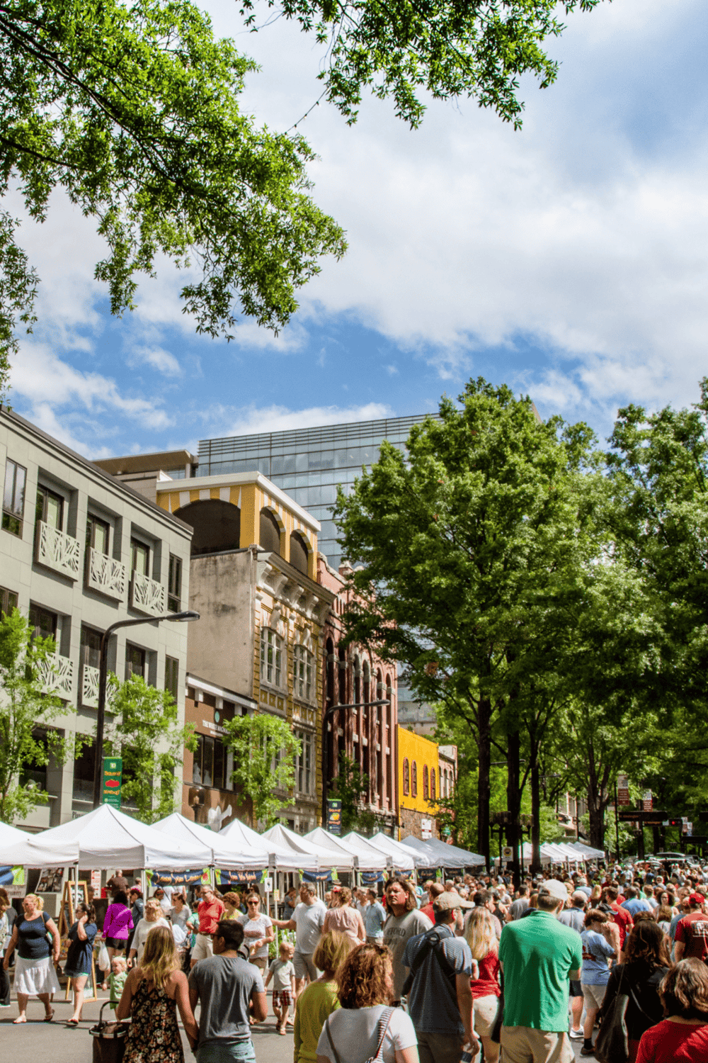 Open-air street festival with vibrant crowd and colorful buildings, showcasing community events, outdoor markets, and city life.