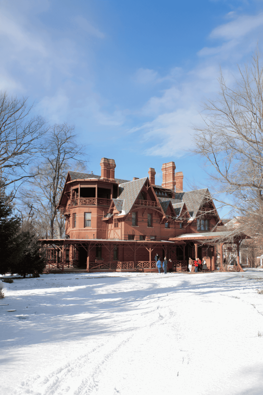 Victorian-style historic house with intricate woodwork on a snowy landscape, perfect for exploring architectural attractions.