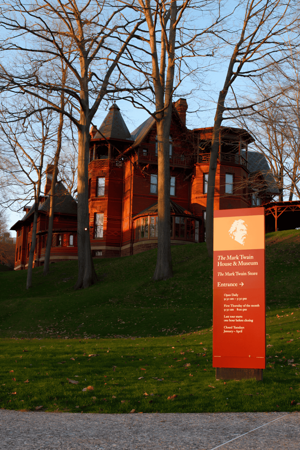 Victorian-style house at Mark Twain House & Museum during sunset, showcasing historic architecture and scenic surroundings.