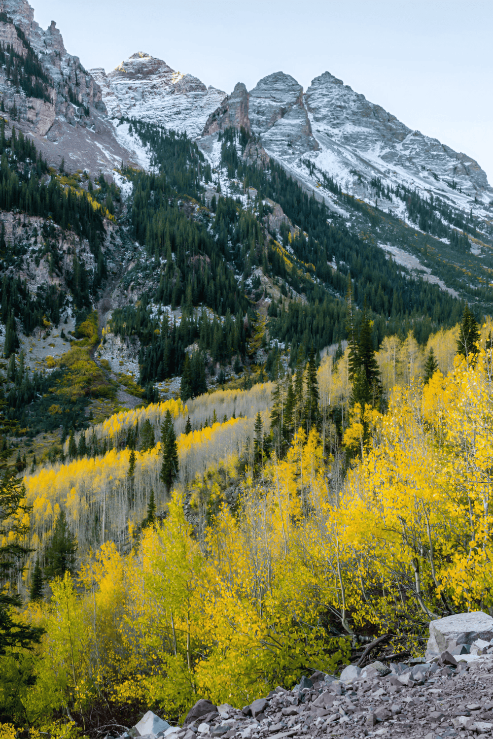 Vivid mountain landscape with snow-capped peaks and colorful fall foliage, capturing natural beauty and adventure.