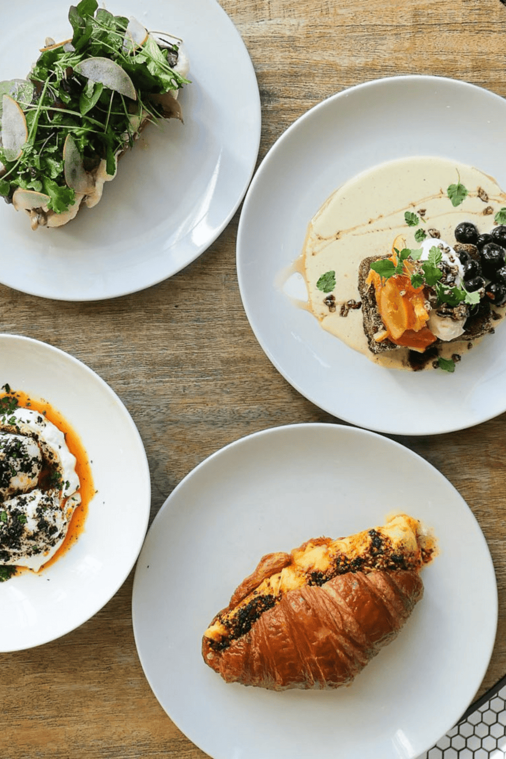 Fresh gourmet dishes including a pastry, salad, and cheese platter, perfect for food lovers and culinary explorers.