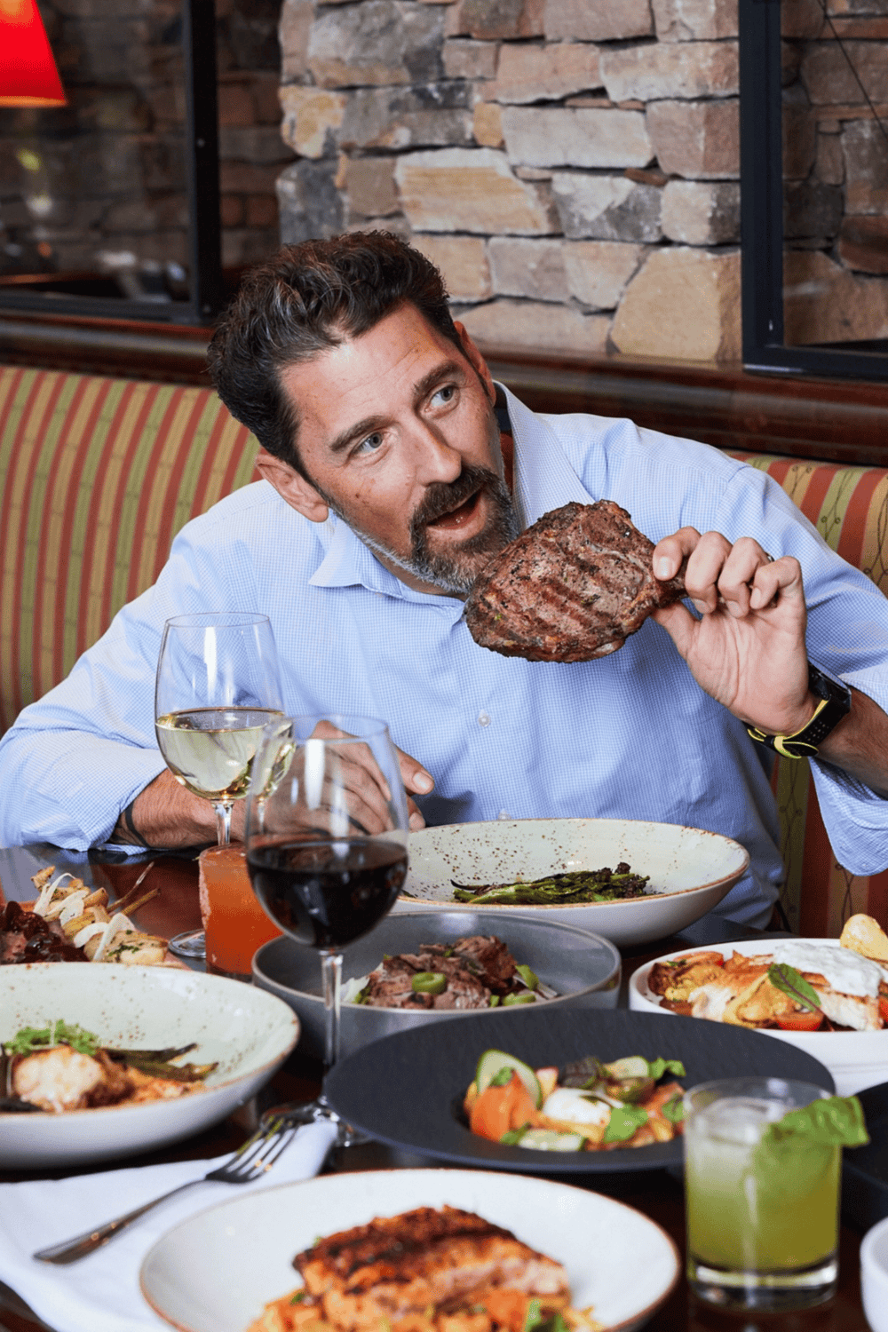 Juicy steak and fine wine at a restaurant, enjoying a delicious meal in a cozy dining setting.