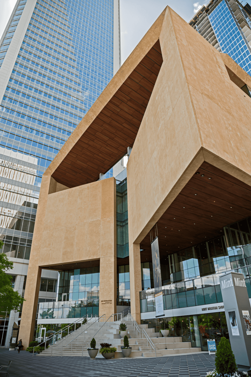 Contemporary urban building with glass and beige architecture in downtown area, modern city design.