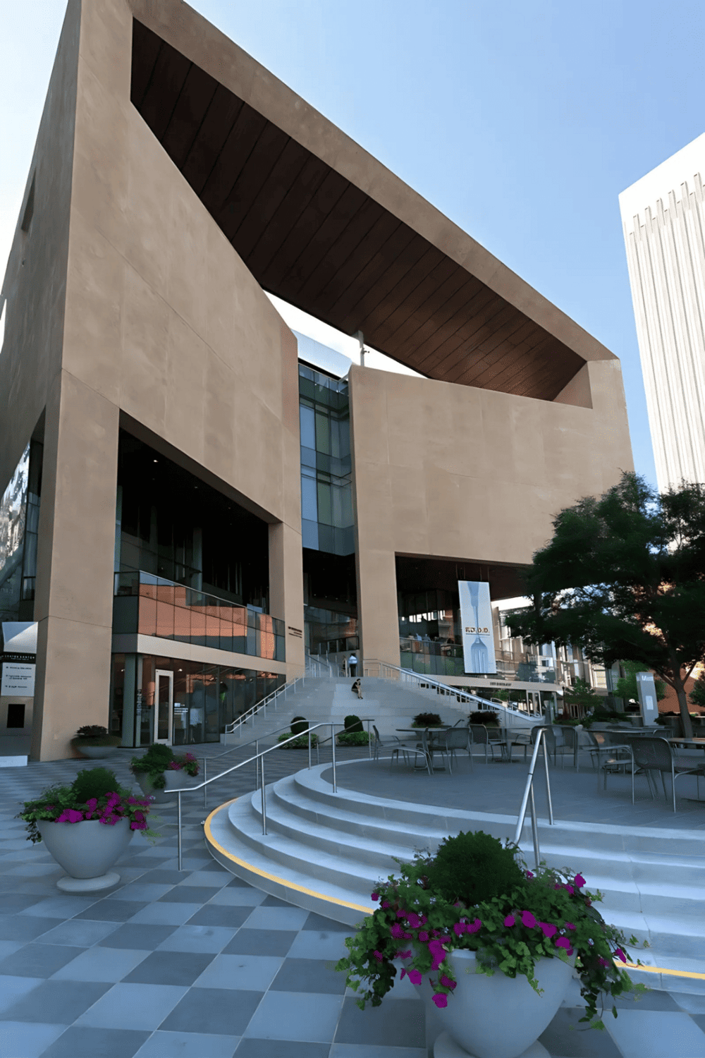 Modern architectural building with QUEST FOR DIRECTIONS signage at the entrance.
