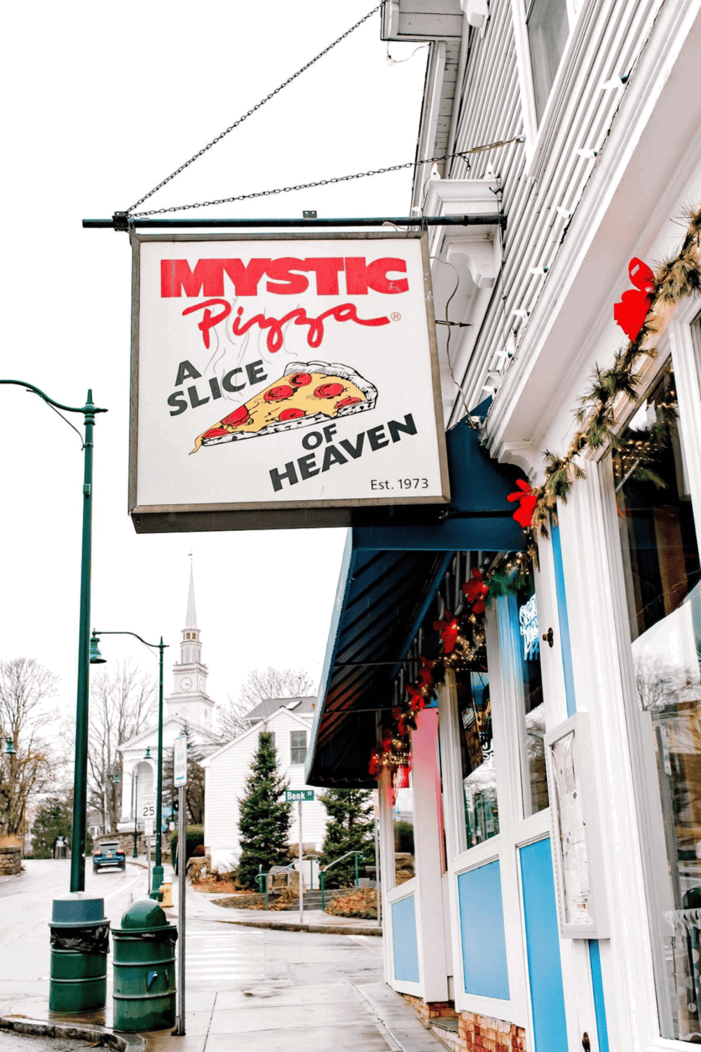 Freshly baked pizza at Mystic Pizza restaurant in Mystic, Connecticut, with a cozy, inviting atmosphere.