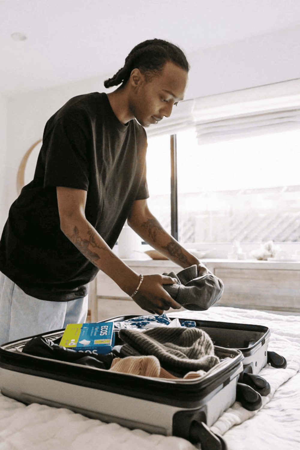 Packing suitcase for travel, organizing clothes for trip, travel preparation, woman packing suitcase.