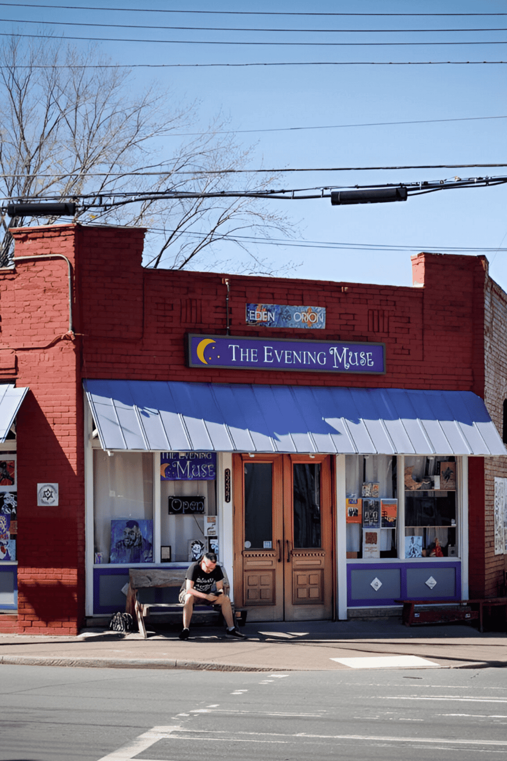 Cozy art shop "The Evening Muse" on a sunny street with a person sitting on a bench, vibrant storefront, and artistic vibe.