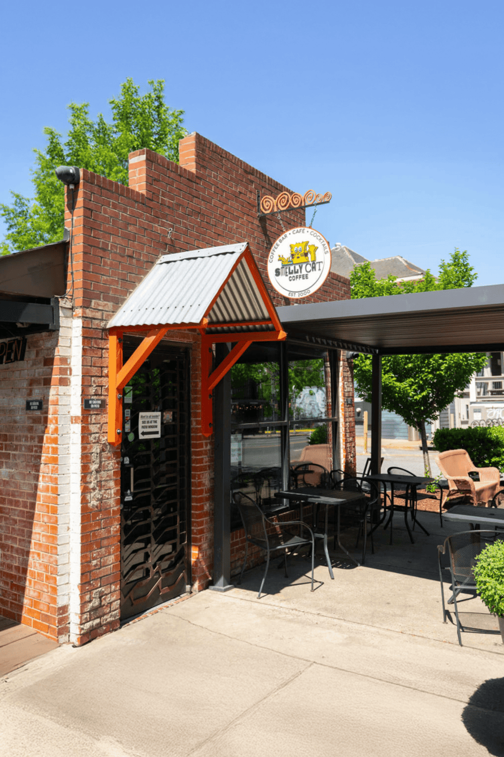 Cozy coffee shop exterior with outdoor seating and a welcoming atmosphere, perfect for relaxing and enjoying beverages.