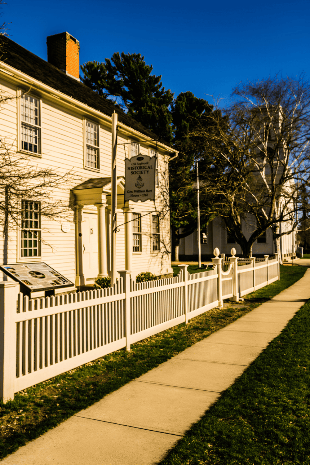1. Historic White House exterior with picket fence and informational sign, old Sanford historical society building.