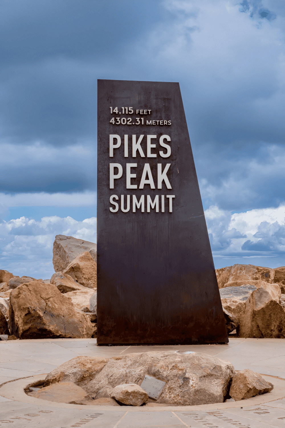 High-altitude mountain peak sign at Pikes Peak, Colorado, with 14,115 feet elevation.