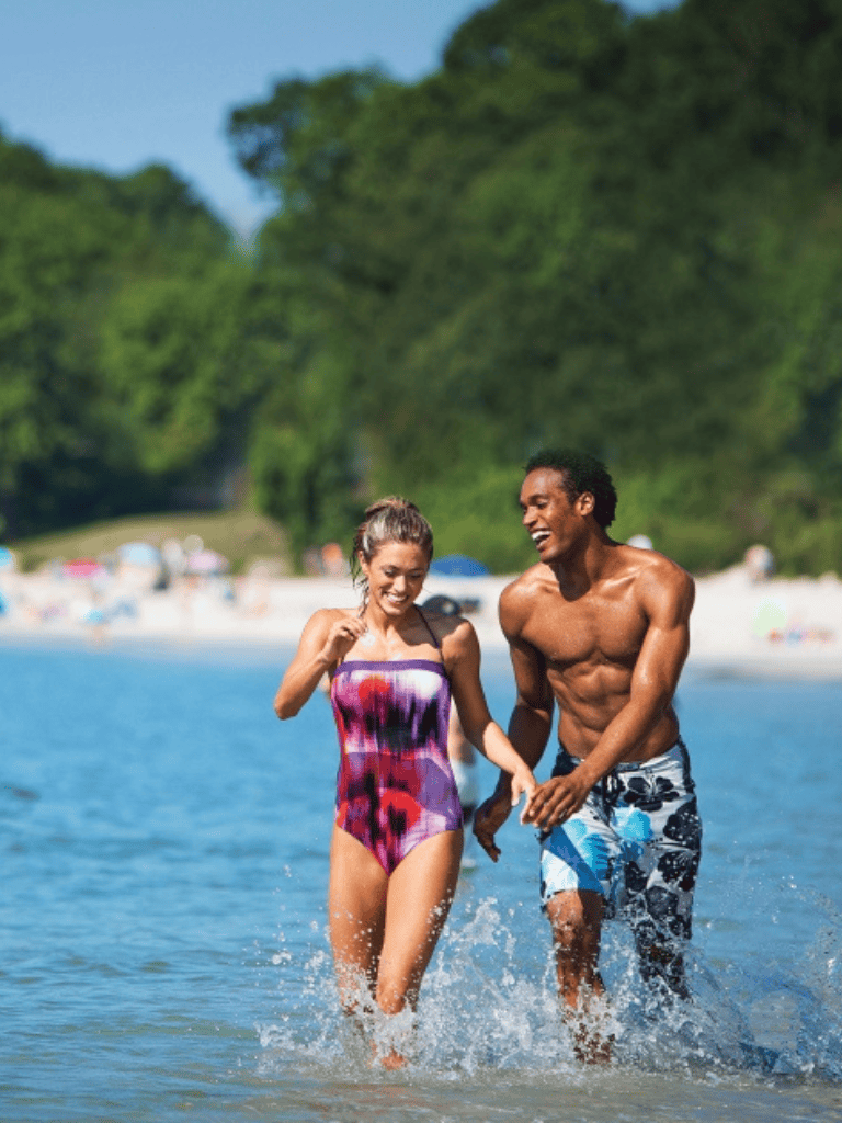 Sunny beach vacation with happy couple, tropical getaway, summer holiday, and travel adventure.