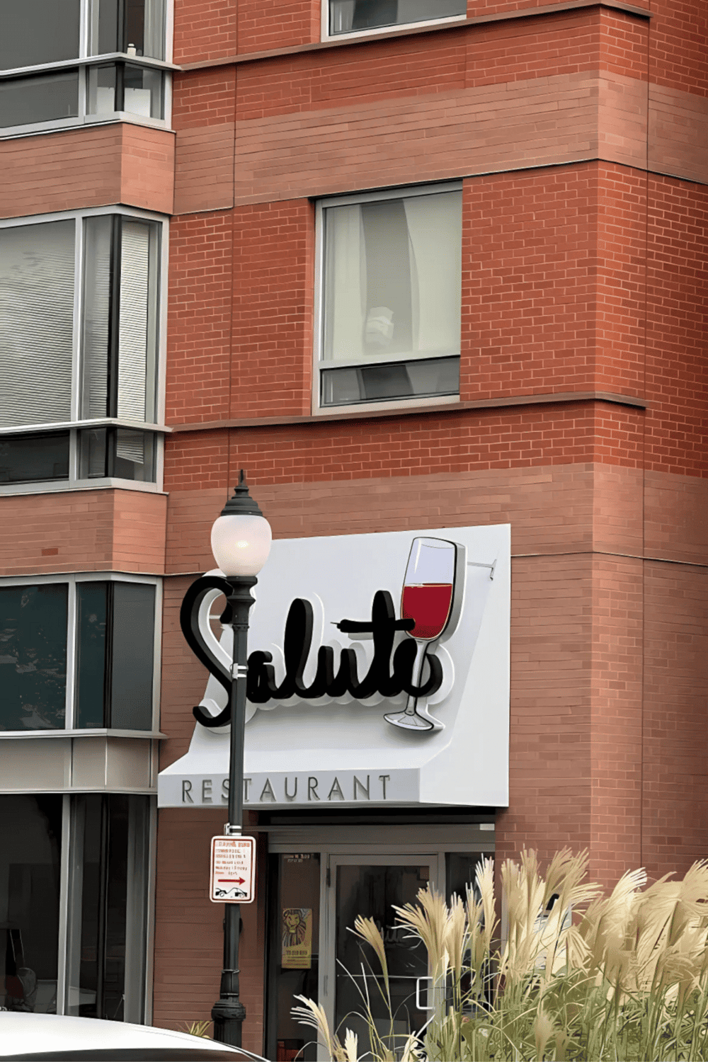 Modern restaurant facade with stylish signage and brick exterior, ideal for restaurant branding and location visibility.