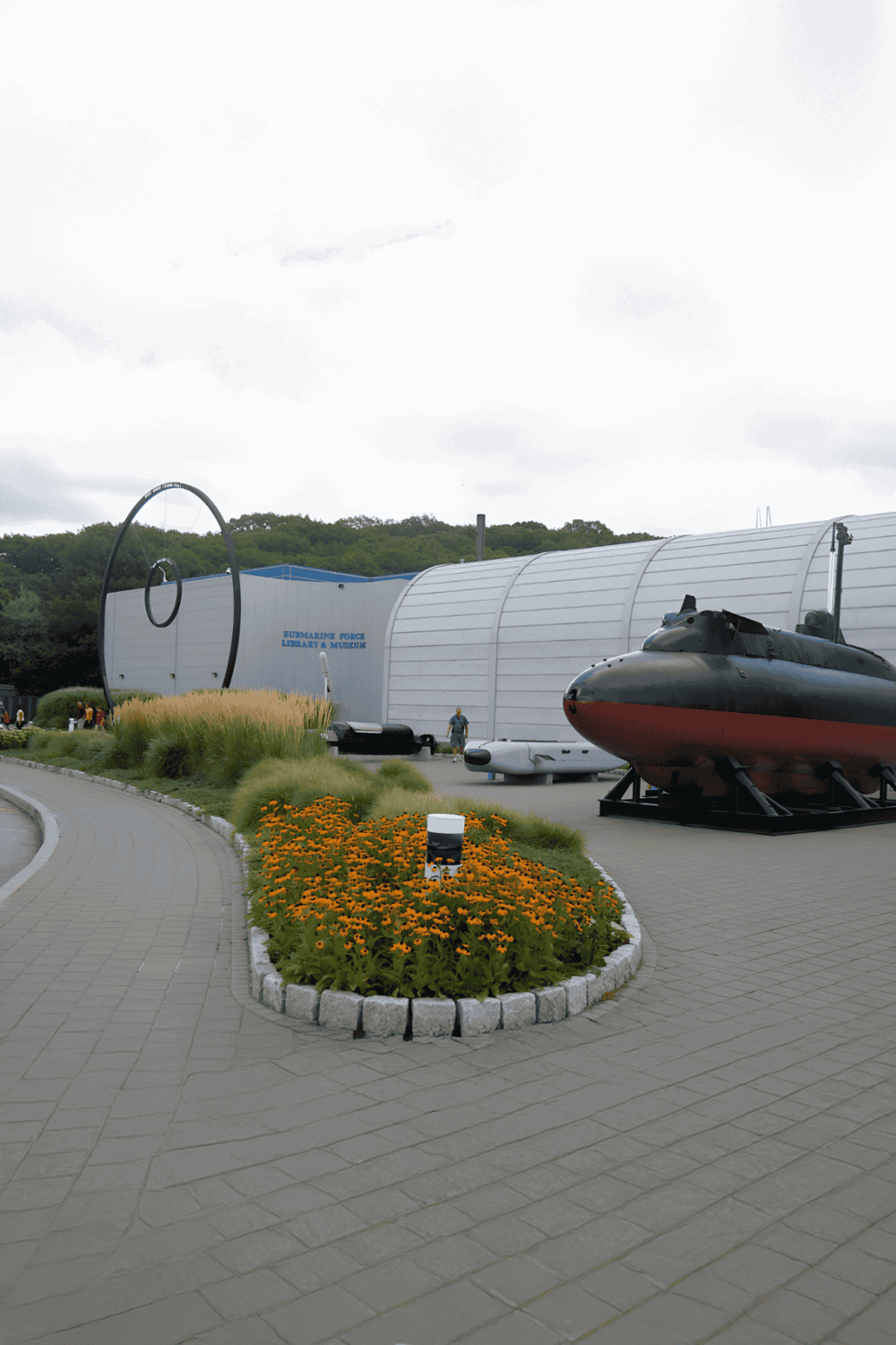 Submarine Force Library & Museum with submarine exhibit, outdoor view, and floral landscaping.