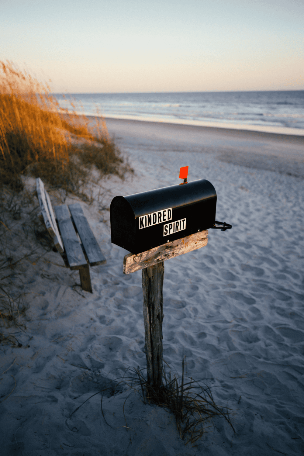 Mailbox with "Kindred Spirit" on a beach scene at sunset.