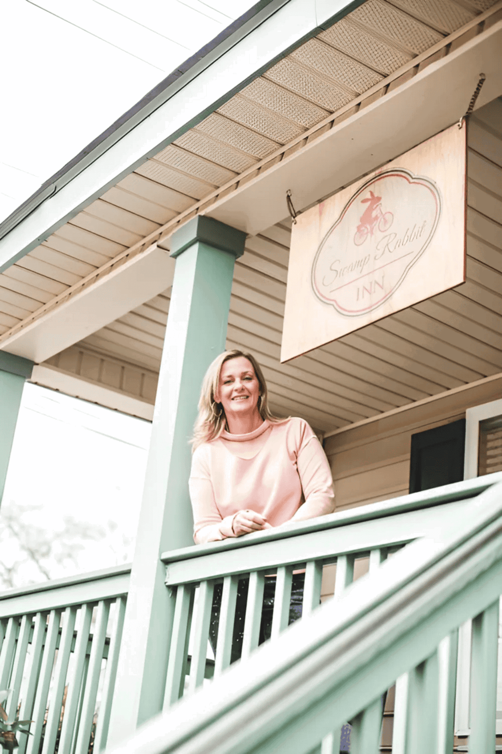 Cozy inn with a welcoming porch and signage, ideal for travelers seeking comfort and charm.