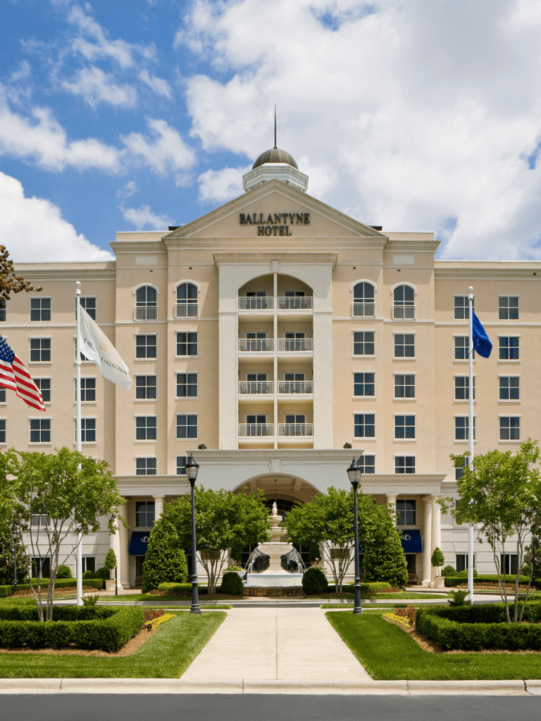 1. Elegant Ballantyne Hotel exterior with lush landscaping and classic architecture.