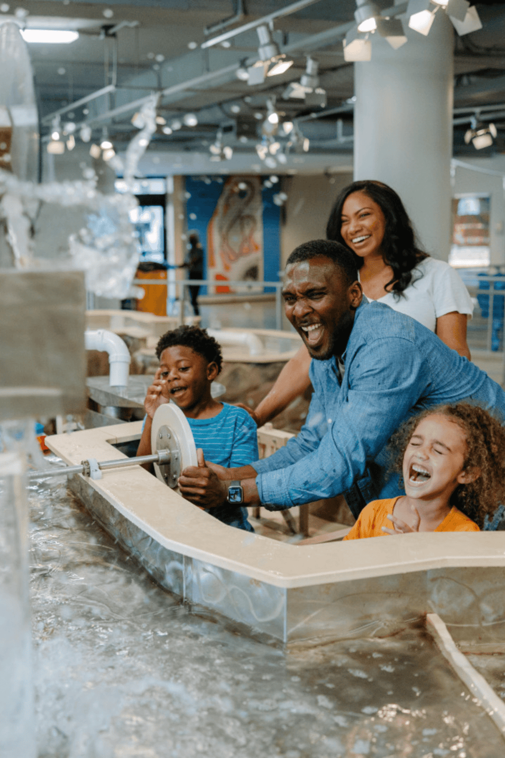 Family enjoying interactive science activities at QuestForDirections.