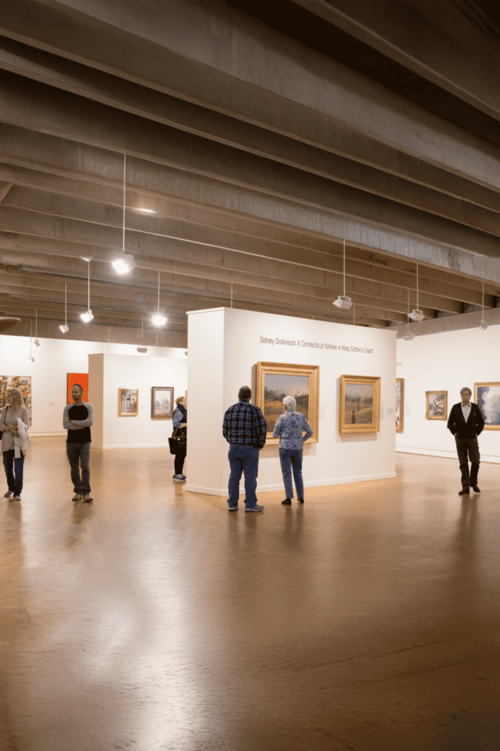 1. Art gallery featuring landscape paintings in a modern museum space.