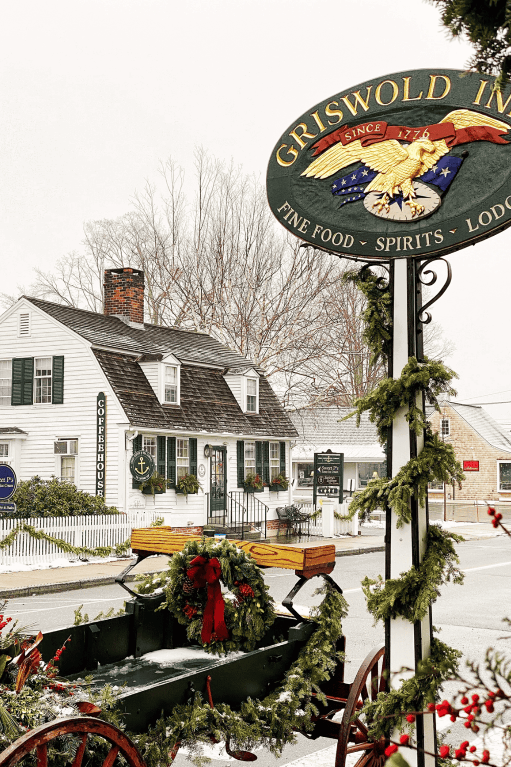 Charming historic tavern with festive holiday decorations in a cozy town setting.