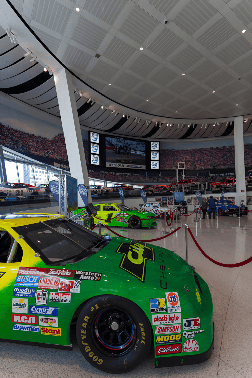 Race car exhibit at the NASCAR Hall of Fame, showcasing iconic racing cars and memorabilia.