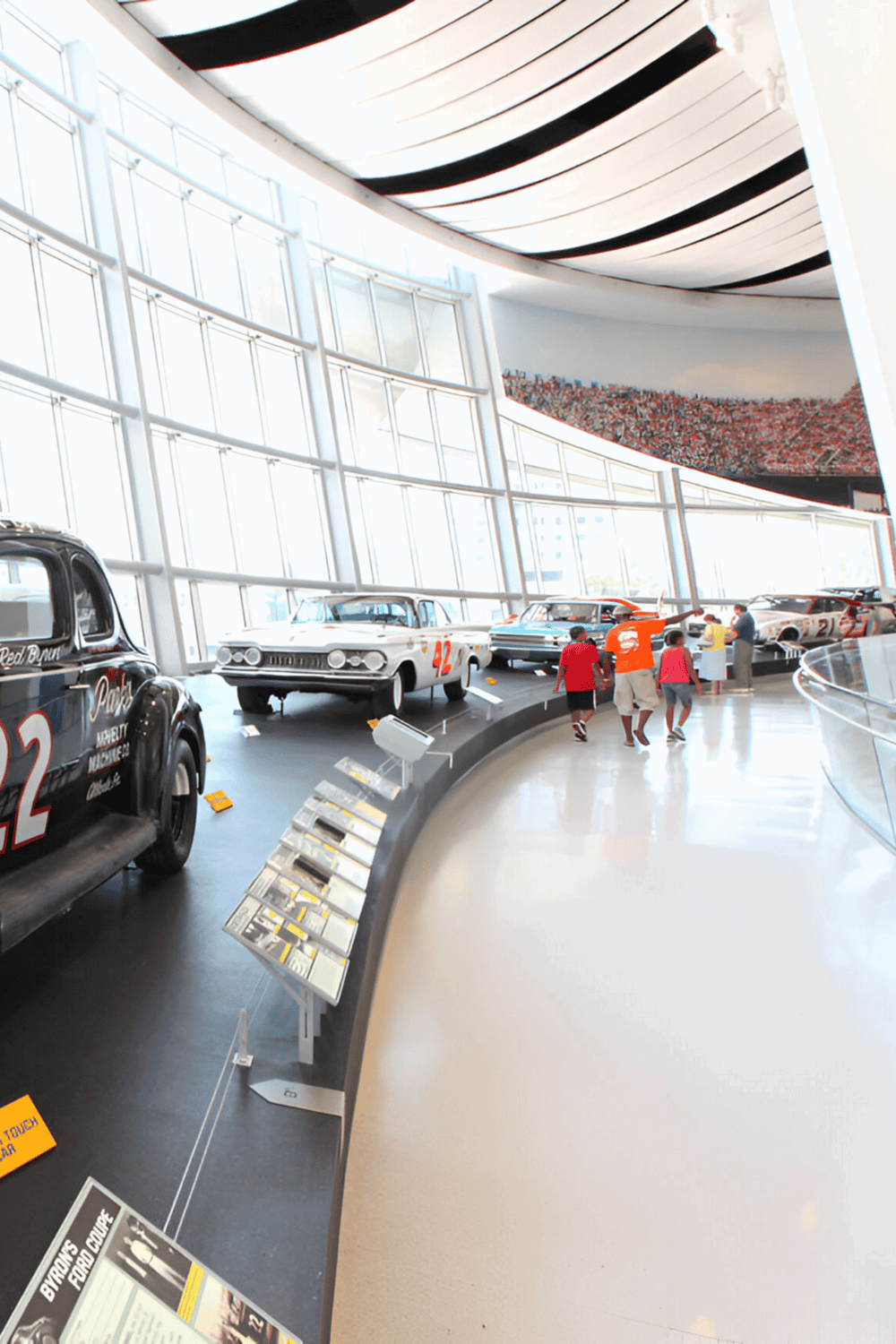 Vintage race cars display at QuestForDirections museum, showcasing automotive history and racing heritage.