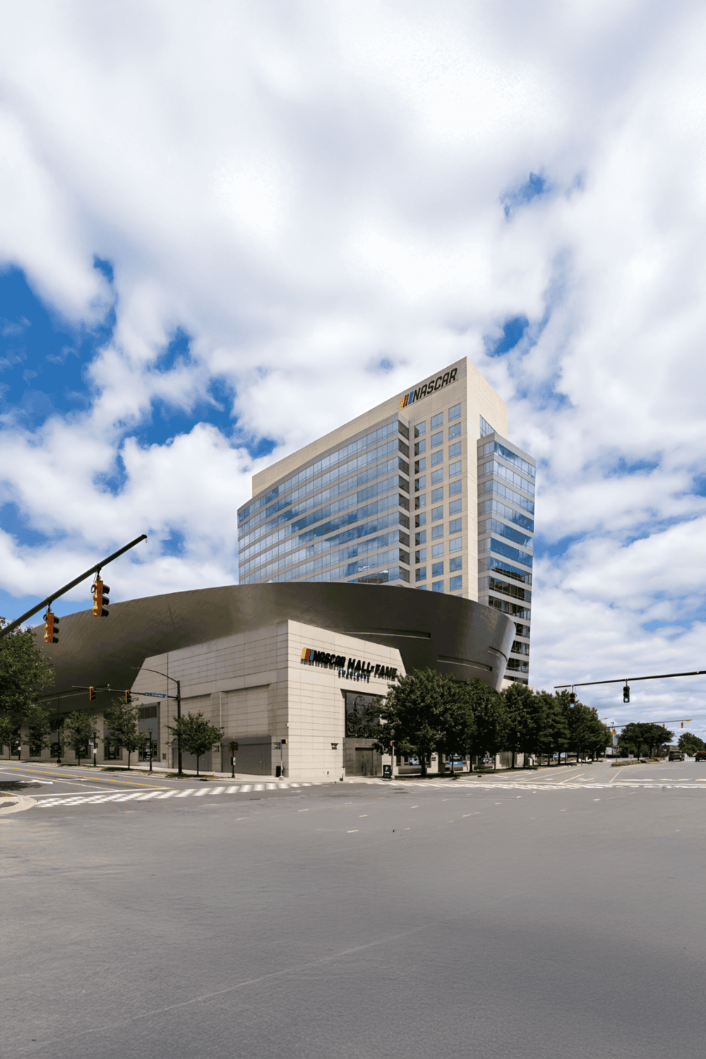NASCAR Hall of Fame building in Charlotte, North Carolina, with clear skies and modern architecture.