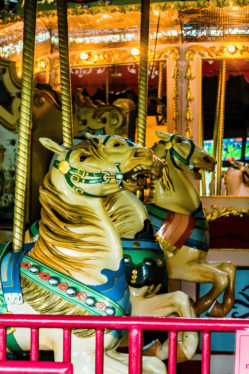 Colorful carousel horses at an amusement park, perfect for family fun and entertainment.