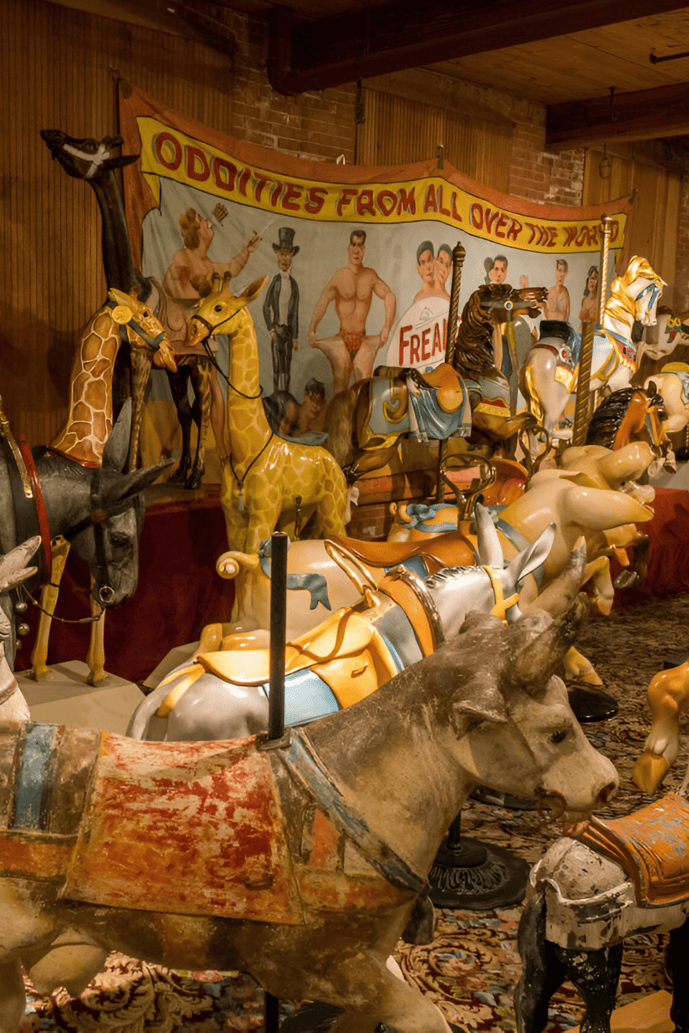 Giant vintage carousel horses and whimsical carnival decorations at Quest for Directions amusement park.
