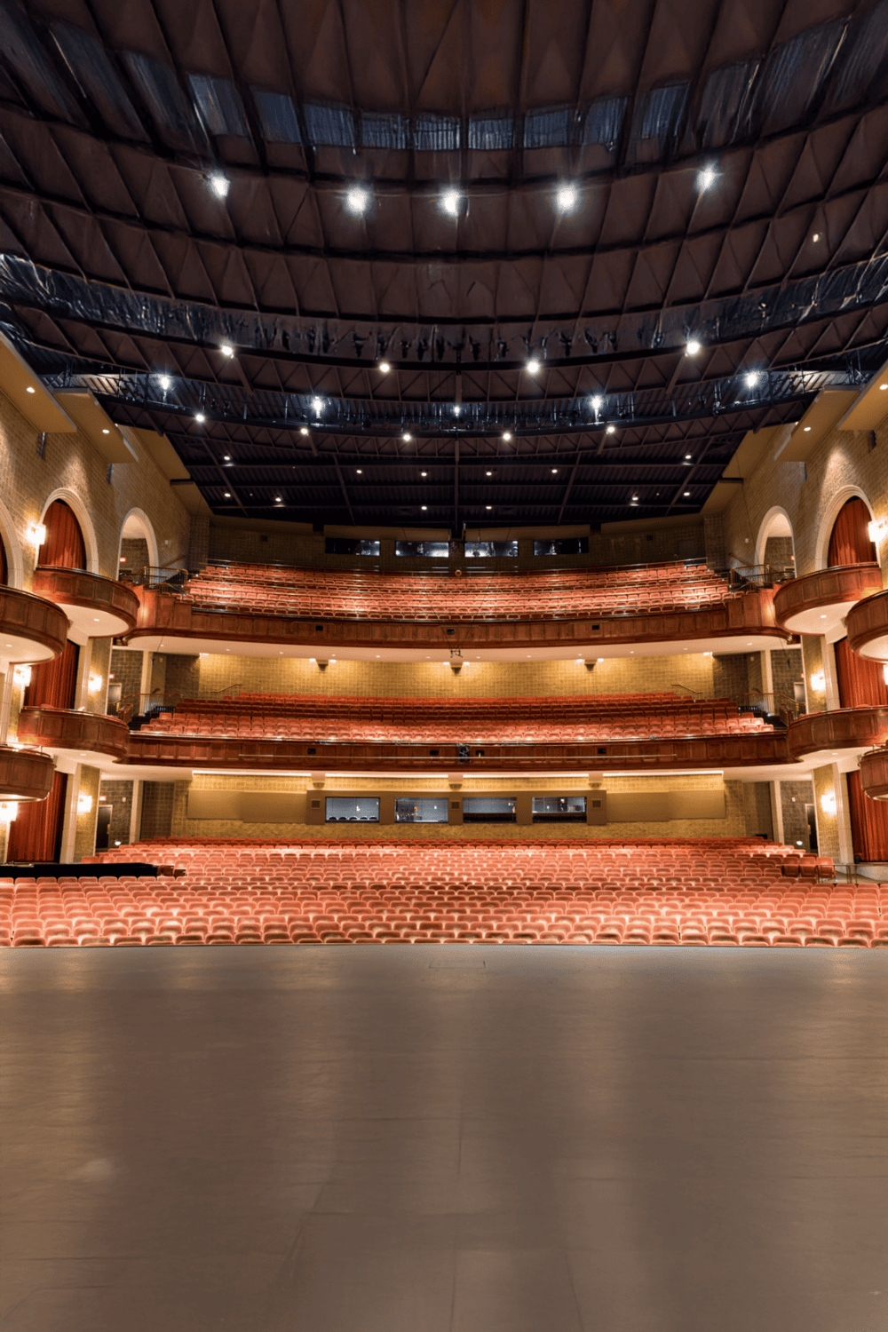 Spacious theater auditorium with tiered seating and advanced acoustics for live performances and events.