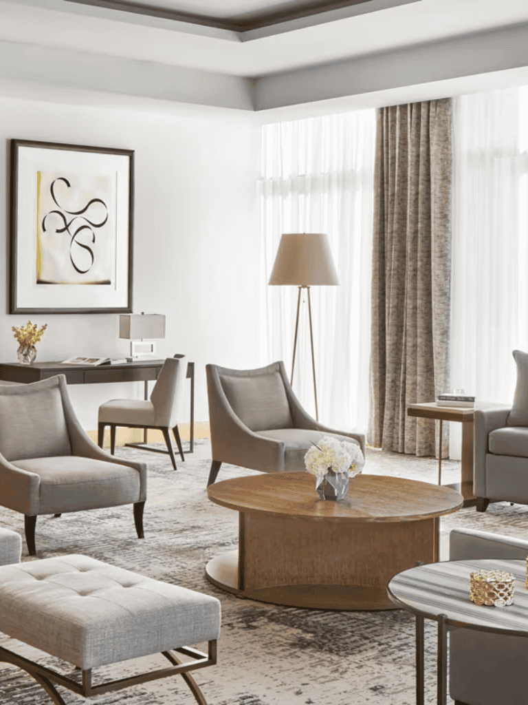 Elegant modern hotel lobby with stylish seating and natural light, ideal for relaxation and socializing.