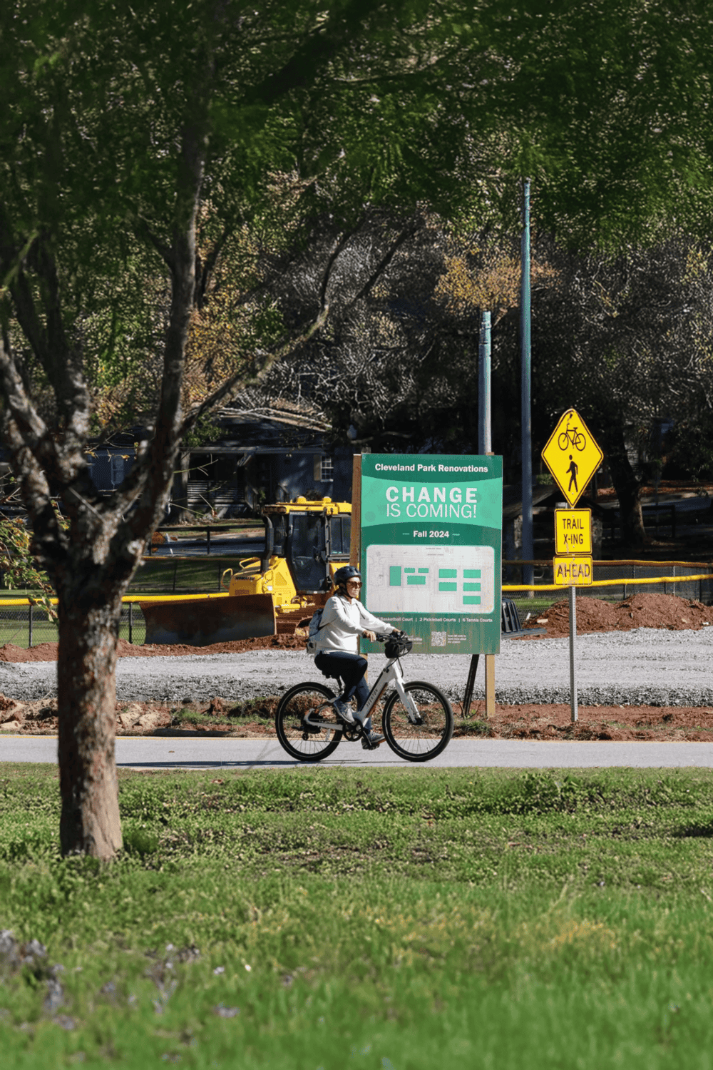 Bike rider at Cleveland Park renovation site promoting community engagement and outdoor recreation.