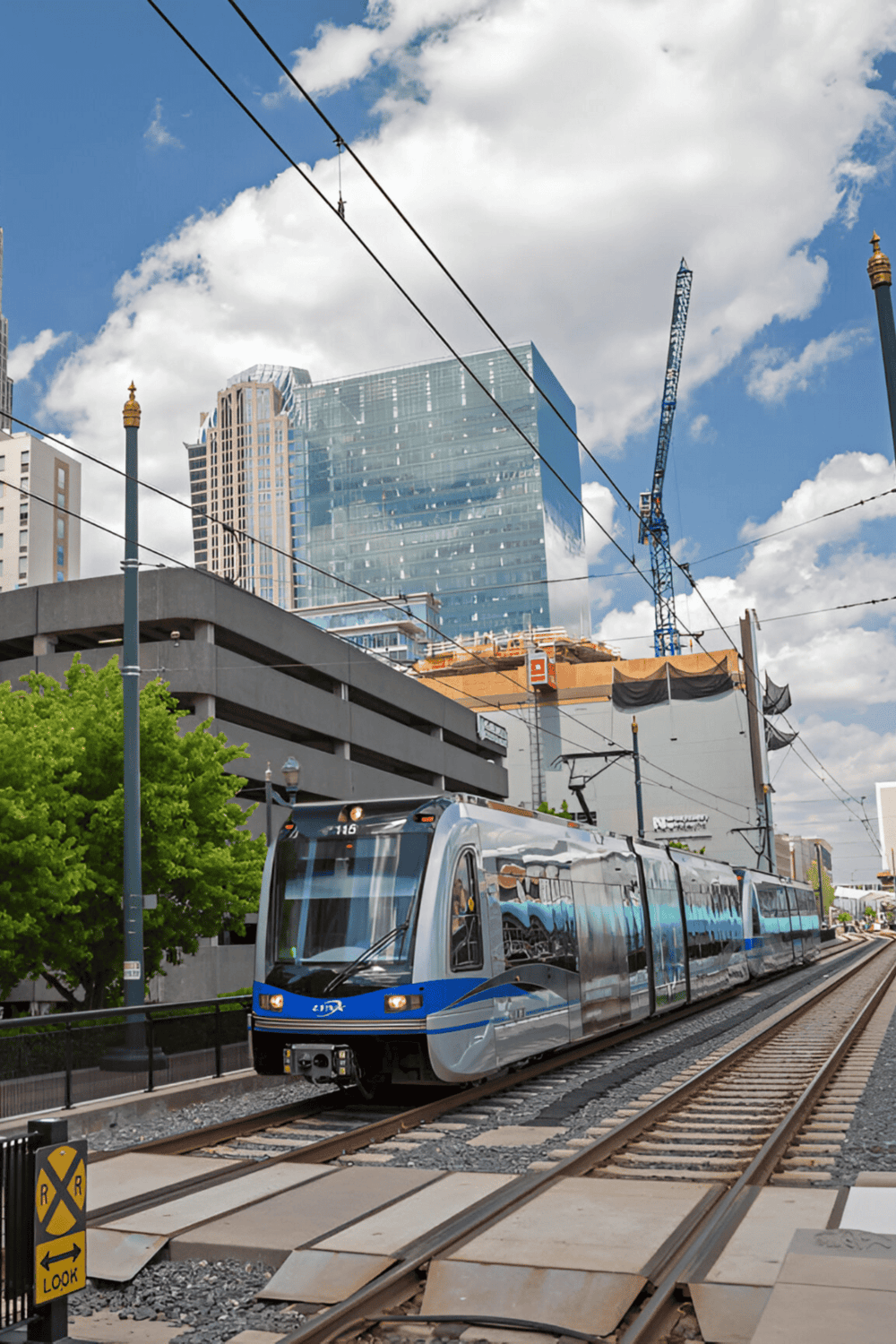 Modern urban tram running through downtown cityscape.