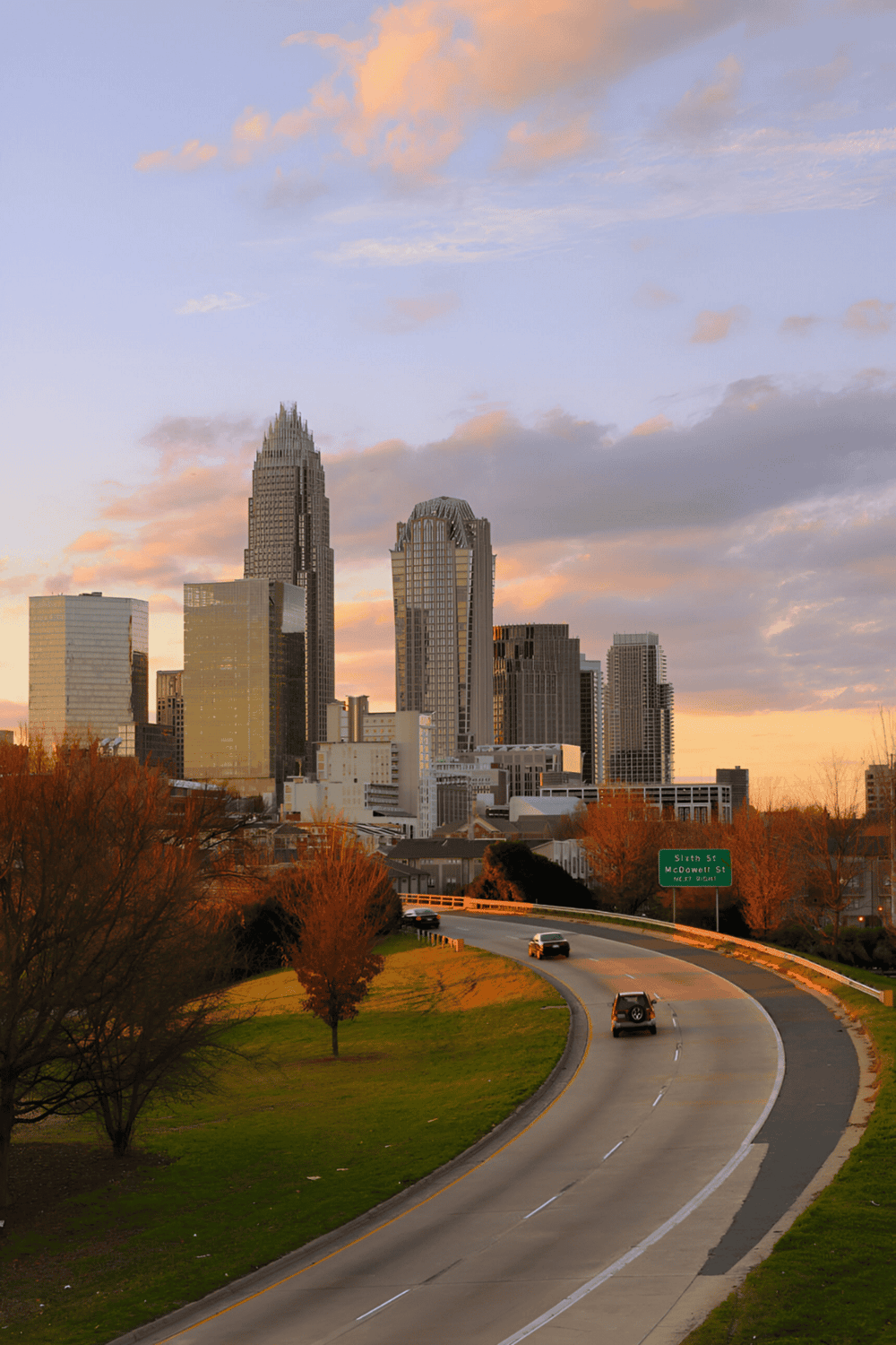 Modern city skyline with high-rise buildings and sunset sky in Charlotte, North Carolina.