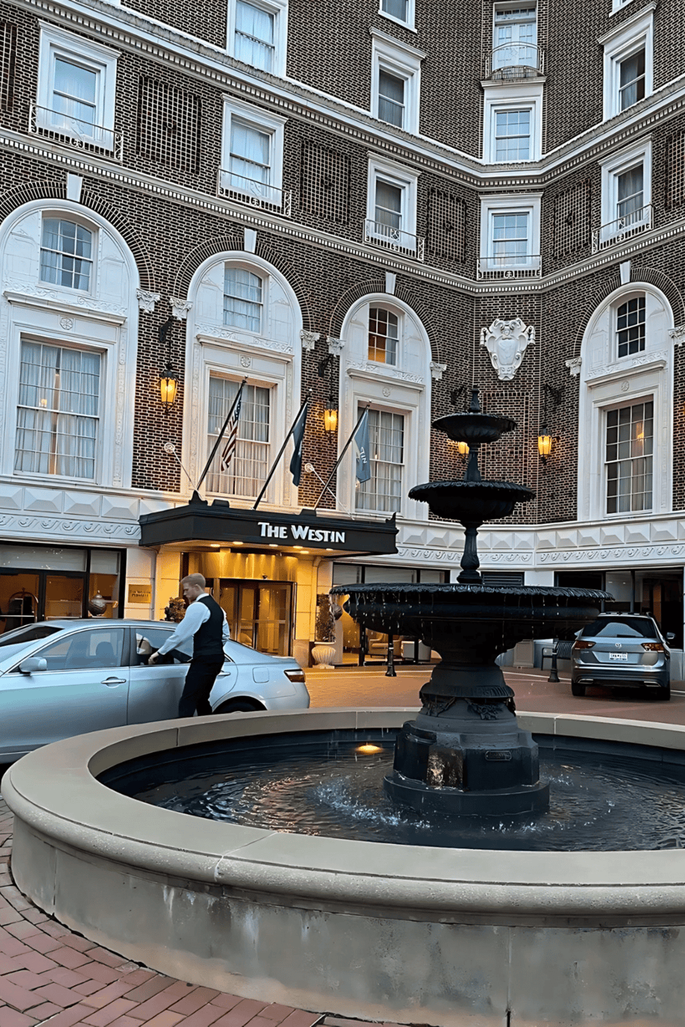 Elegance at The Westin hotel entrance with classic architecture and a scenic fountain.