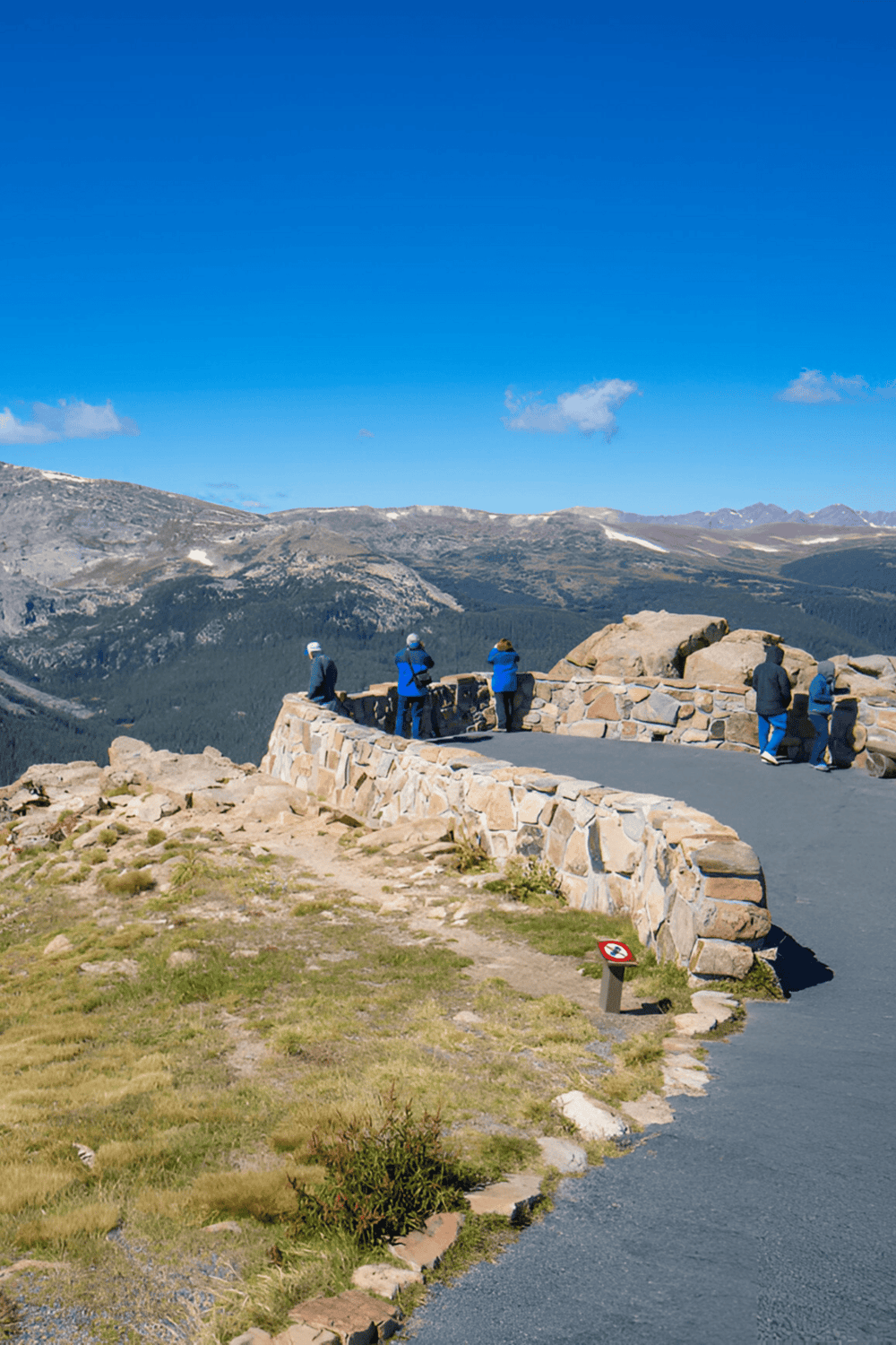 Breathtaking mountain view at QuestForDirections scenic lookout with visitors enjoying the panoramic landscape.