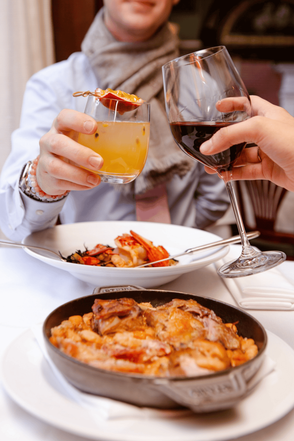 Enjoying fine dining with wine, pasta, and gourmet cuisine at a restaurant.